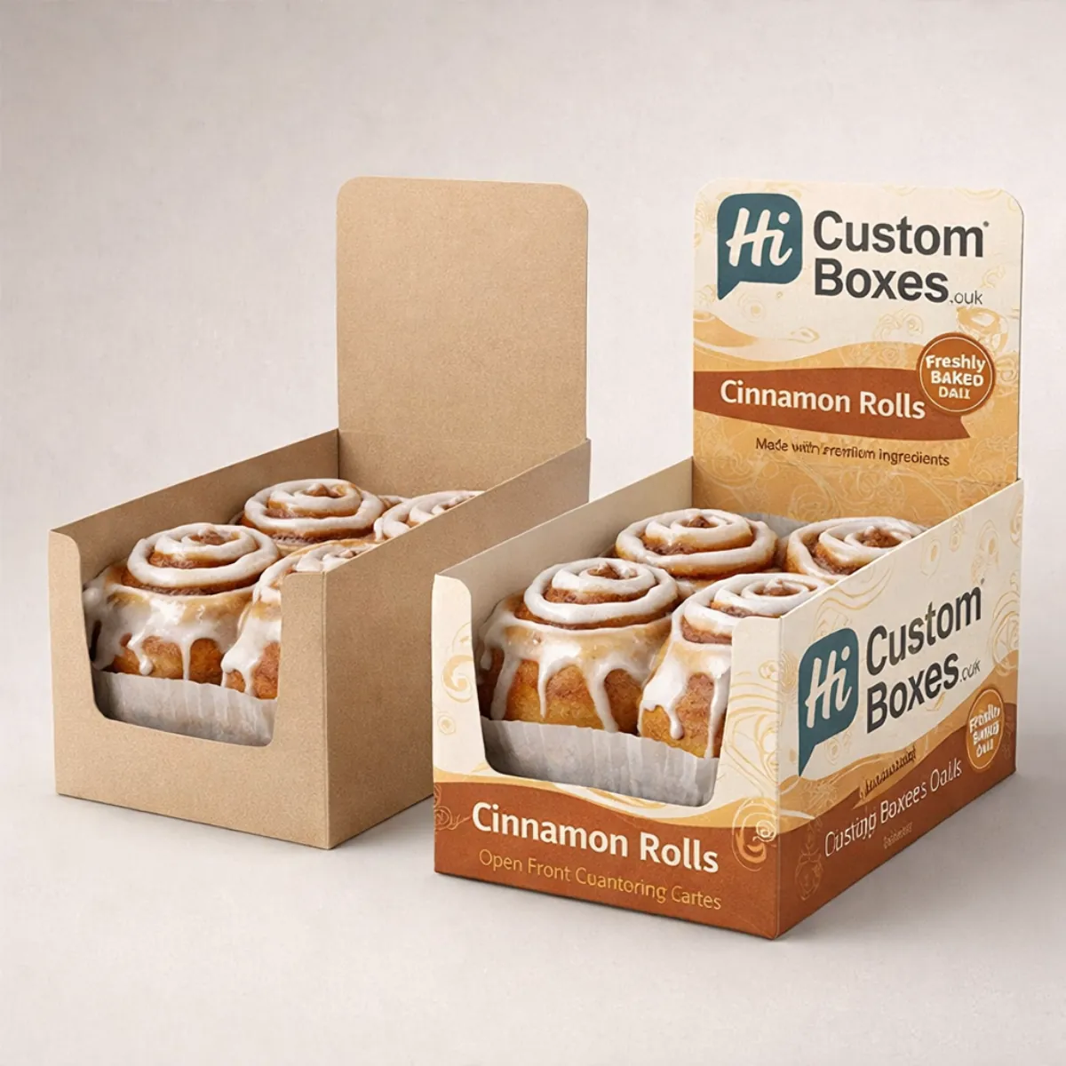 Two open-front counter display boxes showcasing large, gooey cinnamon rolls, designed for retail point-of-sale presentation. class=